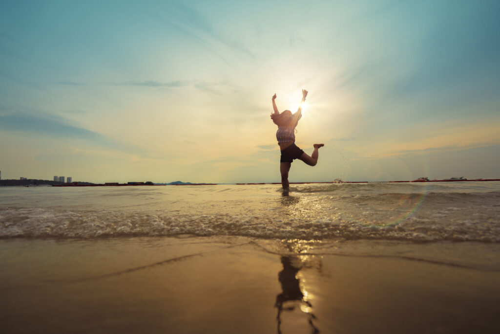 woman-happiness-jump-with-sunset-beach
