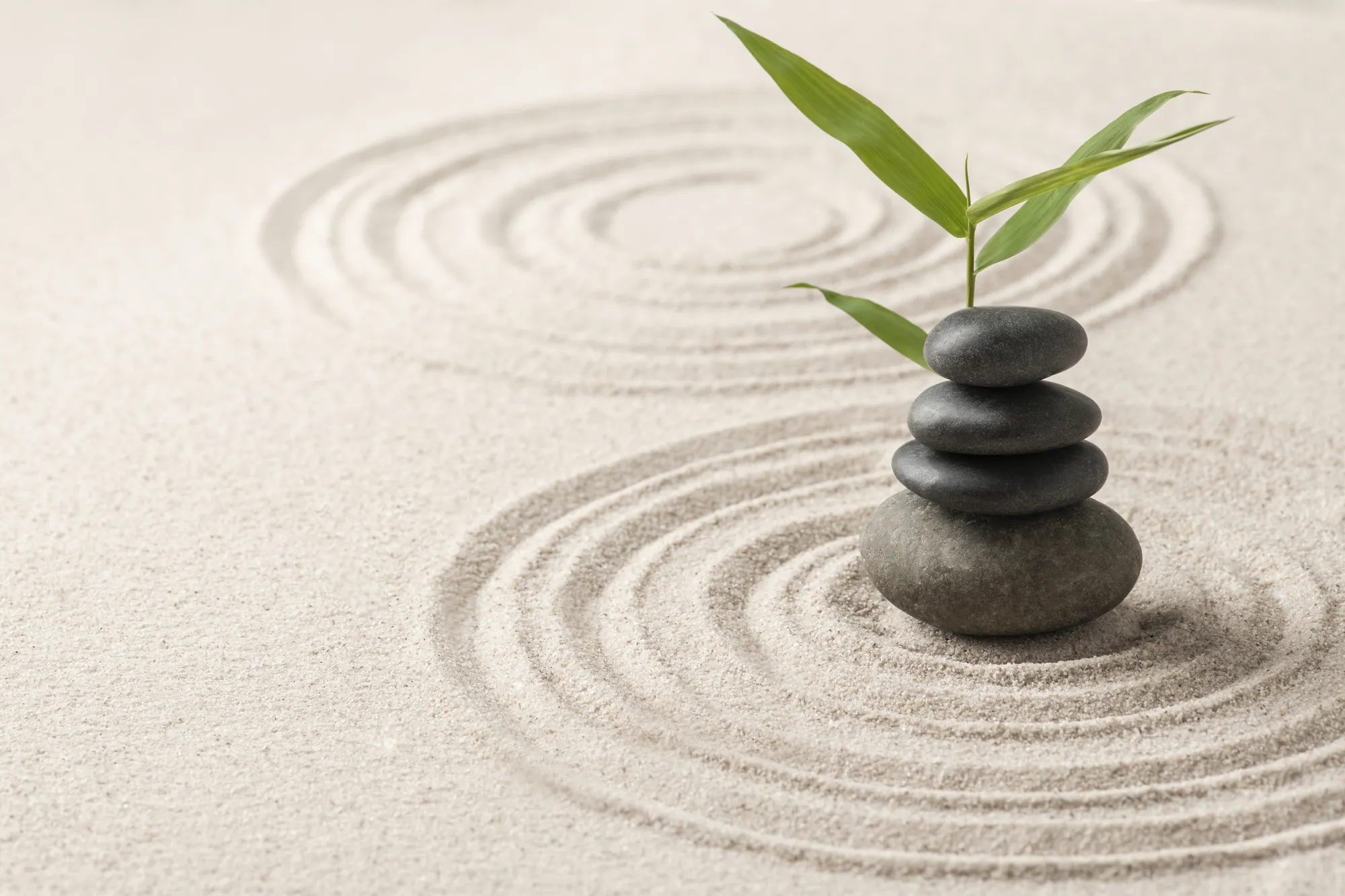stacked-zen-stones-sand-background-art-balance-concept